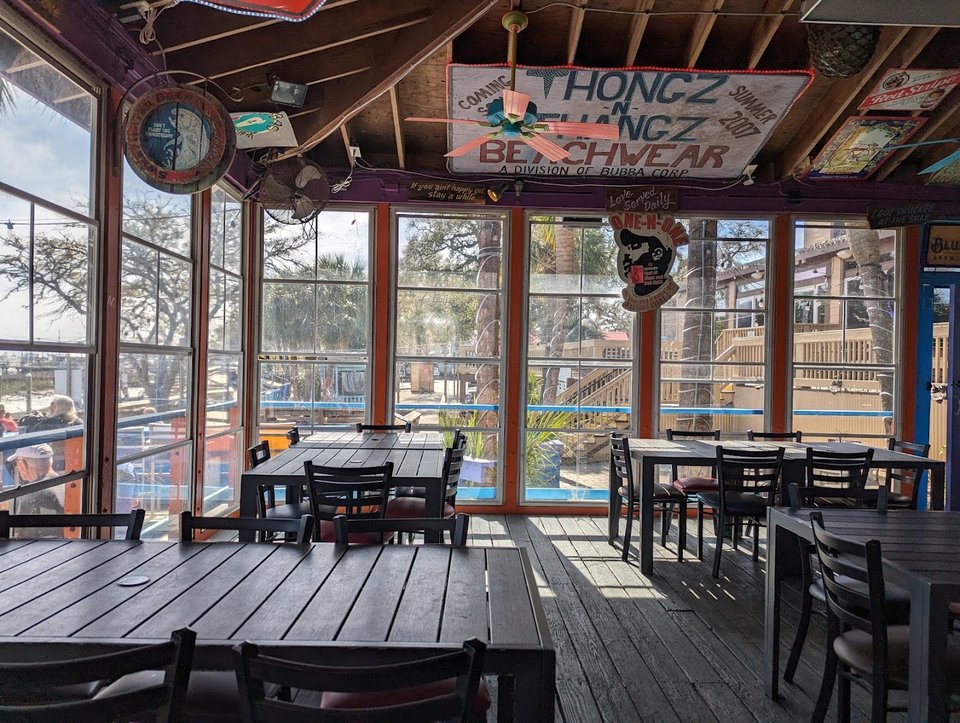 Patio seating beside a casual seafood restaurant.